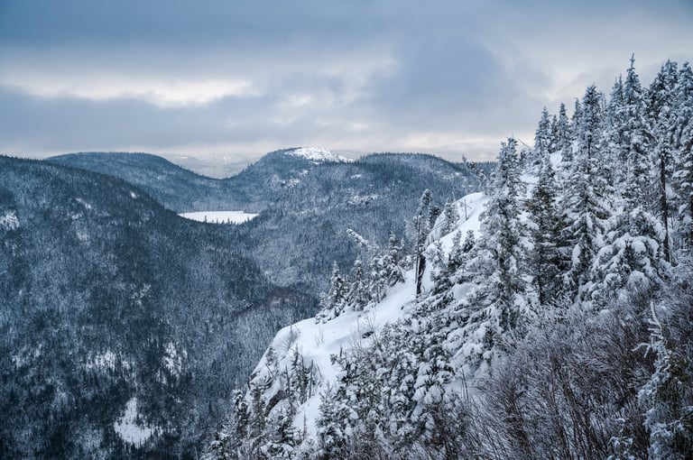 Horizon of high cliffs and mountains on a snowy day at Dome mountain, Charlevoix region, Quebec